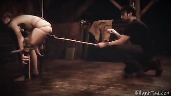 A pretty, gagged blonde whimpers during her BDSM punishment